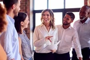 Businesswoman Leading Team Meeting In Busy Multi-Cultural Office