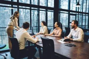 Group of business partners listening to leader